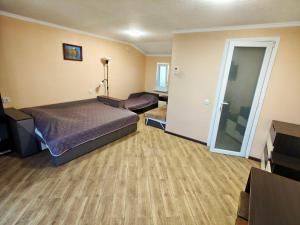 a hotel room with a bed and a mirror at Гостинний дім "Алмаз" in Kurortne