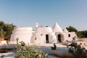 a white church with a domed roof at Trulli Lumena in Ostuni