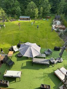 an open field with a tent and chairs and people at Rotonde View in Predeal