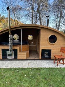 a small house with a stove and a bench at Rotonde View in Predeal