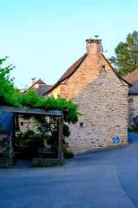 a brick building with a roof with plants on it at Auberge du Fel in Le Fel +6 photos