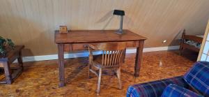 a desk with a lamp and a chair in a room at The Cabin at Solitude Junction in Opdyke