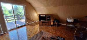 a living room with a large window and a couch at The Cabin at Solitude Junction in Opdyke