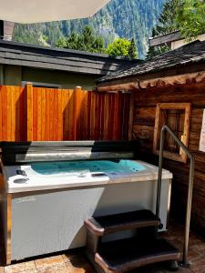 a hot tub in the backyard of a cabin at Hotel Garni Obermair in Mayrhofen