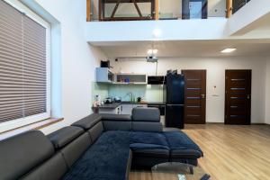 a living room with a couch and a kitchen at Lipove Spa in Lipowe