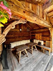 a wooden cabin with two benches and a table at Hotel Garni Obermair in Mayrhofen