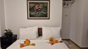 two stuffed animals sitting on top of a bed at 2 Bed Apartment in Colombo 3 in Colombo