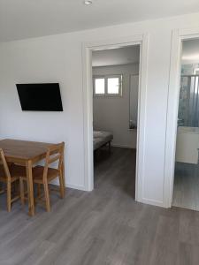 a dining room with a table and a television at Gianola Residence Monolocali Formia in Formia