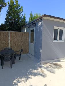 a small shed with a table and two chairs at Gianola Residence Monolocali Formia in Formia