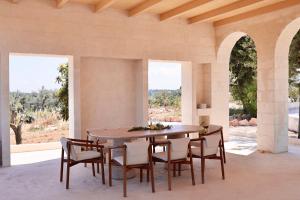 a dining room with a table and chairs at Trulli Lumena in Ostuni