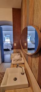 a bathroom with a sink and a mirror at Chateau Tiradentes in Tiradentes +39 photos