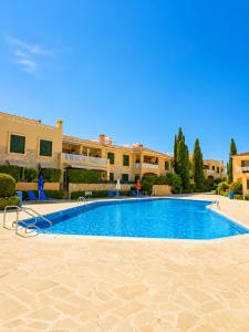 a large swimming pool in front of a building at Athena Apartment in Polis Chrysochous +16 photos