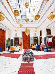 a large room with tables and chairs and ceilings at Riad Dar El Kaid in Fez +81 photos