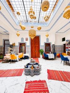 a large room with tables and chairs and chandeliers at Riad Dar El Kaid in Fez