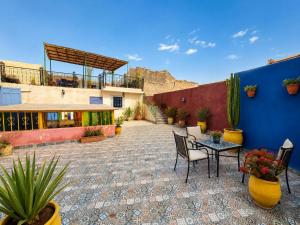 a patio with a table and chairs and a building at Riad Dar El Kaid in Fez