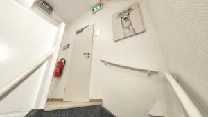 a hallway with a stairway with a white wall at Aparthotel Marion Weber in Bremen