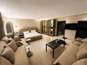 a living room with a couch and a bed at البساتين هومز - Al Basateen Homes in Al Baha