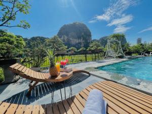 a resort with a pool and a table with a pineapple on it at Tam Cốc AppA House in Ninh Binh