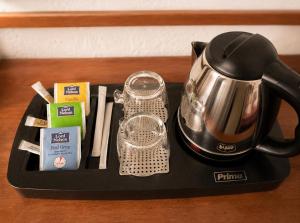 a tray with a tea kettle and other items on it at Sintrivanis Mountain in Áno Skotína