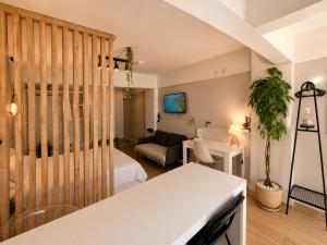 a room with a bed and a living room at Alex Suites Lara in Antalya