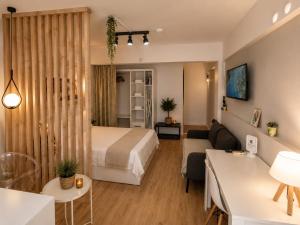 a hotel room with a bed and a living room at Alex Suites Lara in Antalya