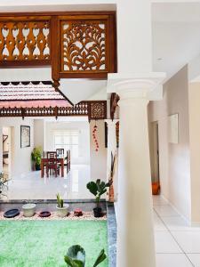 a view of a living room with a table and chairs at Sanskriti in Trivandrum