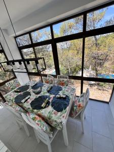 a dining room with a table and chairs and windows at Alcarria , Casa del Agua in Albalate de Zorita