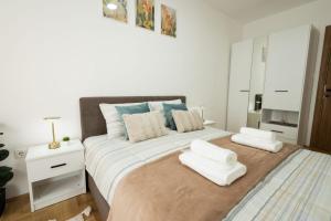 a bedroom with a large bed with two white pillows at Dana in Požarevac