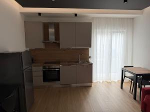 a kitchen with a table and a stove top oven at LumiaRooms B&B in Milazzo