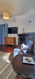a living room with a couch and a fireplace at Chateau Tiradentes in Tiradentes