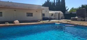 a swimming pool in front of a house at Casa La Ermita in Montmesa