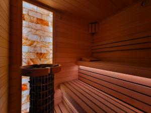 an empty sauna with a stone wall at BELMAR Park Resort in Władysławowo
