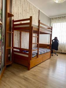 a bedroom with two bunk beds and a desk at Марсельская Residence in Kryzhanivka +15 photos