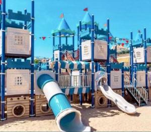 a playground with a slide in front of a play structure at Марсельская Residence in Kryzhanivka