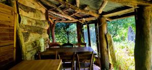 a dining room with a table and chairs in a cabin at Le portillon des fées in Sost