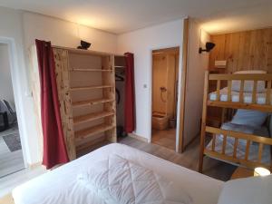 a bedroom with a bed and two bunk beds at Profitez de la vue in Ustou