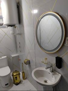 a bathroom with a sink and a mirror at Nofin Lake House in Panjakent