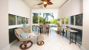 a screened in porch with a chair and a table at 207 Mariners Club in Key Largo
