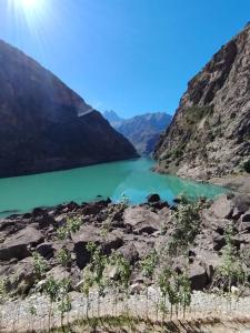 a view of a lake in the mountains at Nofin Lake House in Panjakent +5 photos