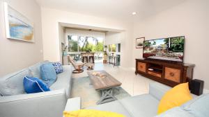 a living room with a couch and a flat screen tv at 207 Mariners Club in Key Largo