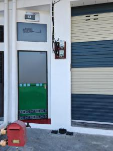 a pair of garage doors on a building at Tetiba Suite in Muar +3 photos