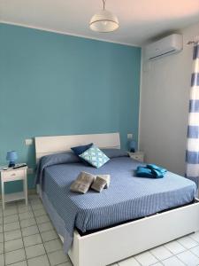a blue bedroom with a bed with two pillows on it at B&B Orizzonte Blu in Maratea