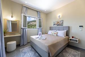a bedroom with a large bed with a window at Nikos & Vassilis apartments Kefalonia in Vlachata