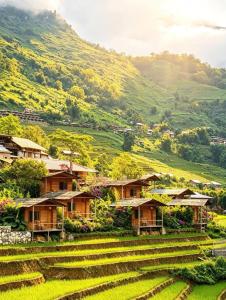 a village in the middle of a green hillside at SaPa Farmer House in Sapa