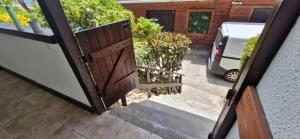 an open door to a driveway with a car parked outside at Lodge Ti Bonheur in Sainte-Anne +40 photos