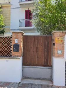 a wooden gate in front of a house at Casettafiore in Civitavecchia
