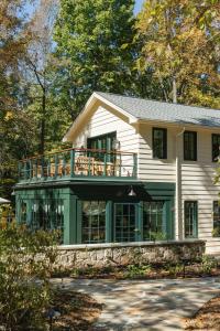 a white house with a balcony on top of it at RT Lodge in Maryville