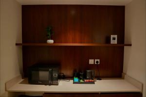 a microwave sitting on a counter in a room at Sambac hotel in Jeddah
