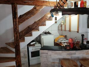 a kitchen with a counter top and a staircase at Vikendica Peace in Brezje