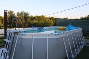 a hot tub in a backyard with at Vikendica Peace in Brezje